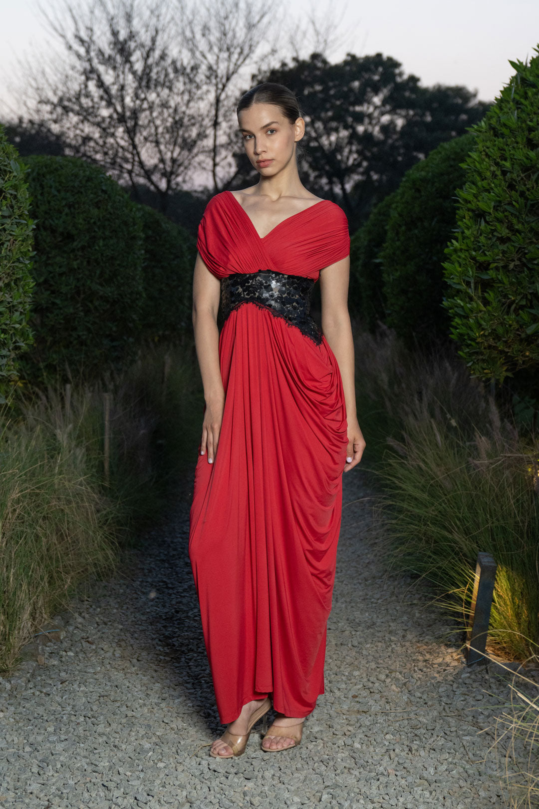 RED DRAPED EVENING GOWN WITH EMBELLISHED WAIST DETAIL