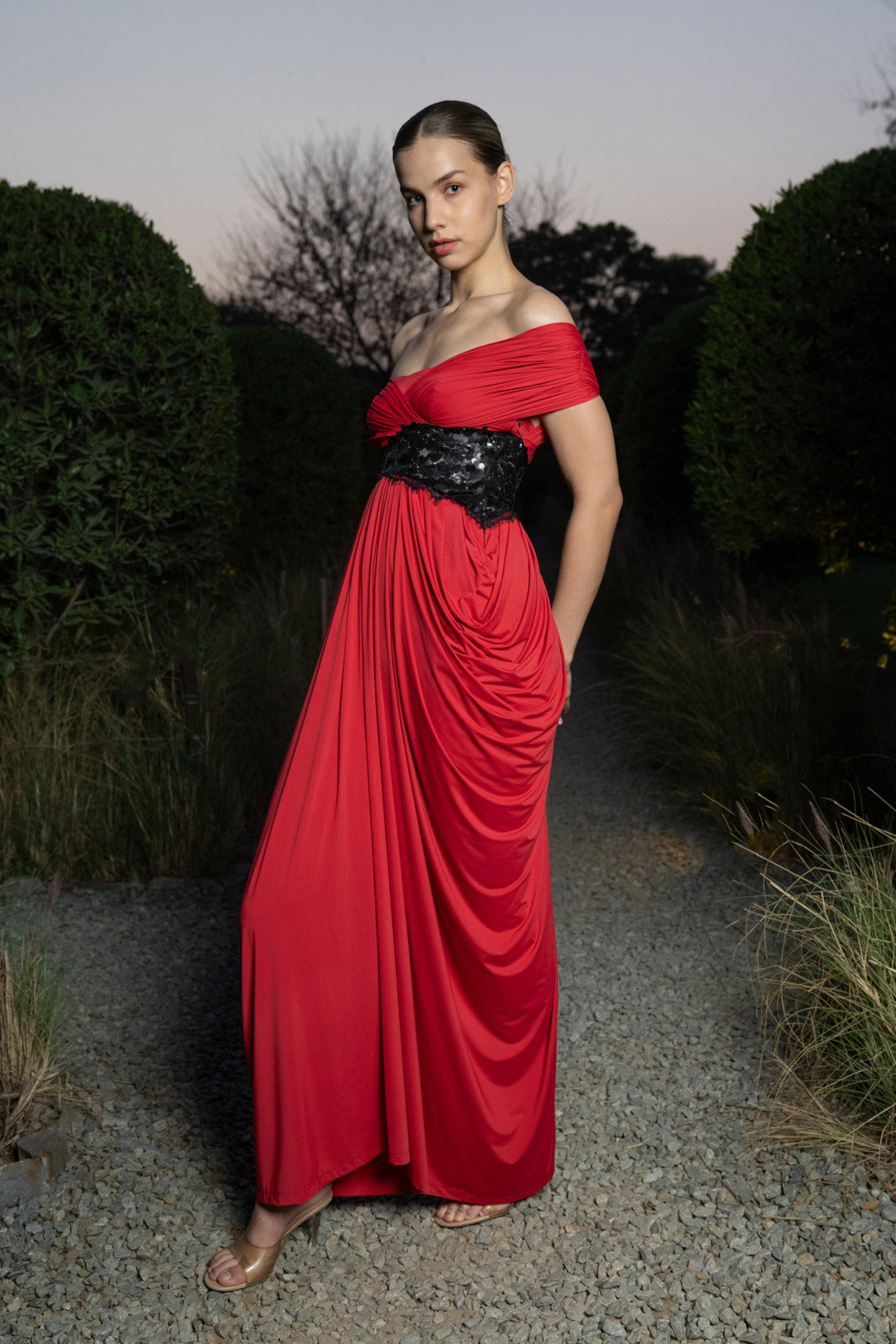 RED DRAPED EVENING GOWN WITH EMBELLISHED WAIST DETAIL